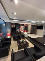 modern living room with black leather sofas and red lamps