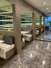 modern lounge area with seating booths and marble flooring