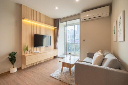 Modern living room with wooden paneling and large window