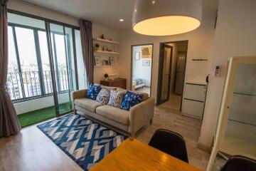 Modern living room with balcony, decorated with contemporary furniture.