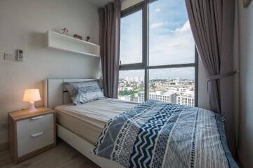 Cozy bedroom with large window and city view