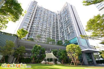 Modern high-rise residential building with landscaped garden