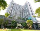 Modern high-rise residential building with landscaped garden