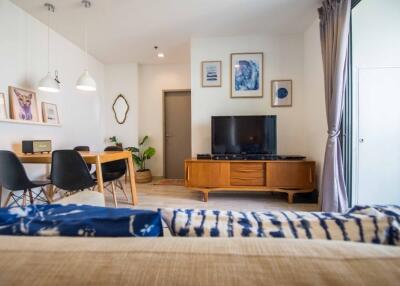 Bright and modern living room with a dining area and a TV unit