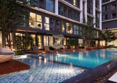 Modern apartment complex with swimming pool and lounging area