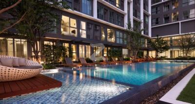 Modern apartment complex with swimming pool and lounging area