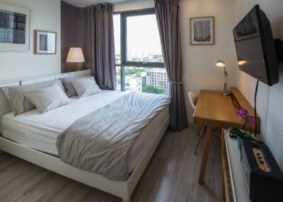 Modern bedroom with a large window and well-lit workspace