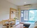 Bright living room with dining area and large window