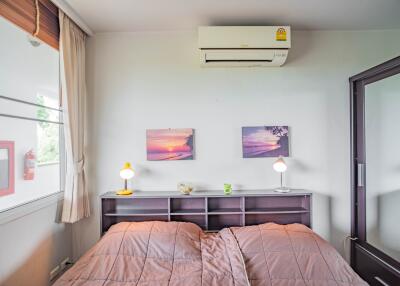 Cozy bedroom with air conditioning and twin artwork