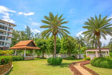 Well-maintained garden area with gazebo and palm trees