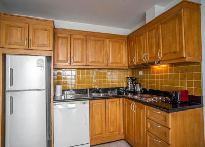 Modern kitchen with wooden cabinets and stainless steel appliances