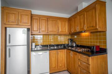 Modern kitchen with wooden cabinets and stainless steel appliances