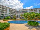 Exterior view of apartment complex with swimming pool