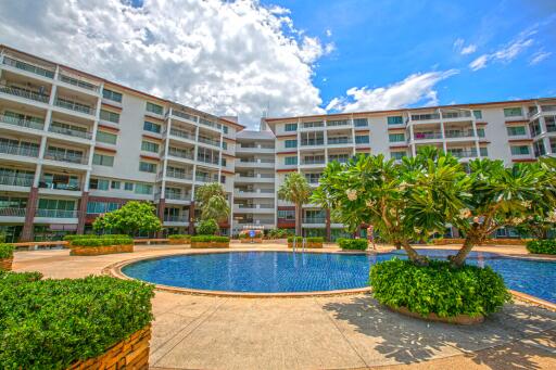 Exterior view of apartment complex with swimming pool