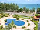 View of pool area with ocean in the background