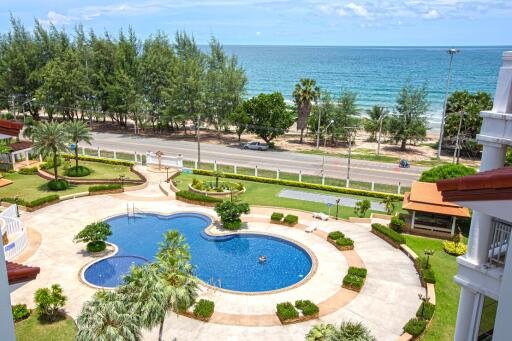 View of pool area with ocean in the background