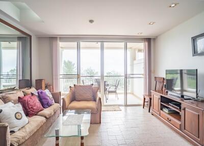 Bright living room with large windows and a balcony