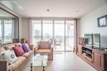 Bright living room with large windows and a balcony