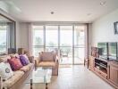 Bright living room with large windows and a balcony