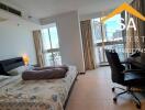 Spacious bedroom with double bed, desk, and city view