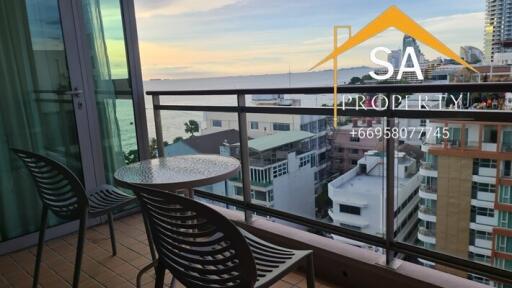 Balcony with chairs and table overlooking city and ocean view