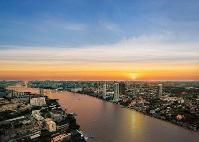 Aerial view of a city at sunset with a river running through it