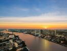 Aerial view of a city at sunset with a river running through it