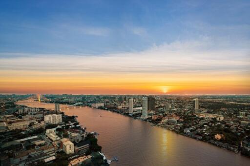 Aerial view of a city at sunset with a river running through it