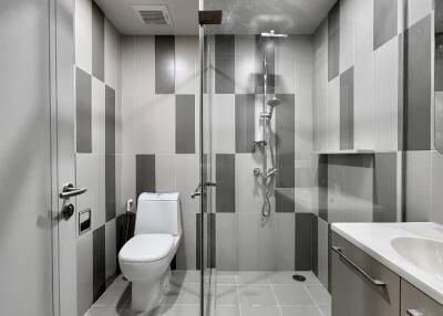 Modern bathroom with glass shower and tiled walls