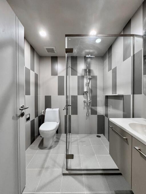 Modern bathroom with glass shower and tiled walls