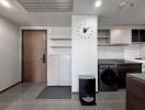 Modern laundry room with washing machine and clock