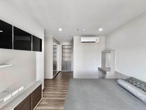 Modern living space with built-in shelves and air conditioning