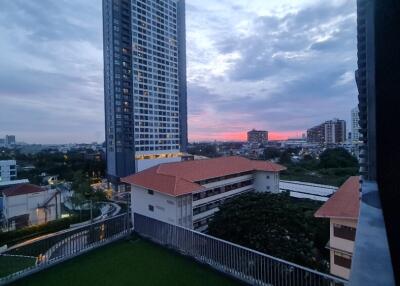 View of high-rise buildings and residential area at sunset