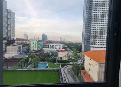 View from a window in a high-rise building overlooking a cityscape