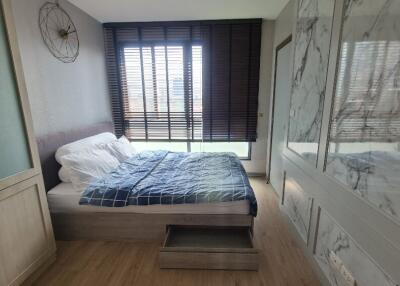 Modern bedroom with large window and built-in storage