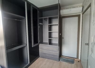 Bedroom with built-in wardrobes and air conditioner