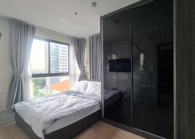 Bedroom with a large window and modern furnishings