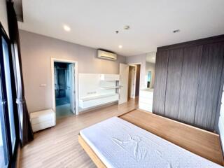 Spacious modern bedroom with large window and ensuite bathroom