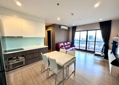 Modern combined kitchen and living room area with dining table