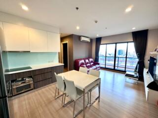 Modern combined kitchen and living room area with dining table