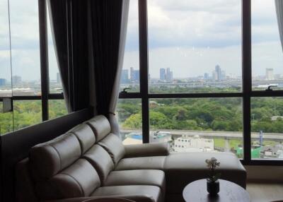 Living room with large windows and city view