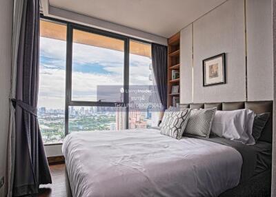 Cozy bedroom with a large window and city view