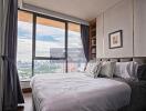 Cozy bedroom with a large window and city view