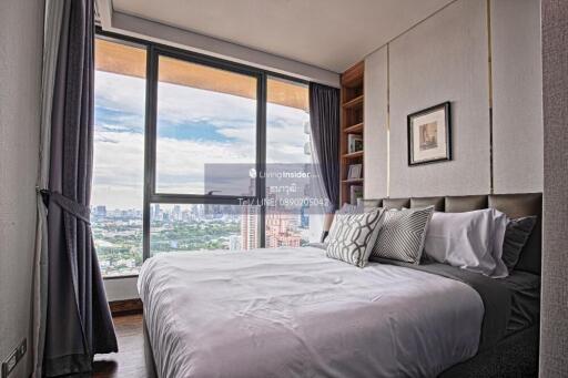 Cozy bedroom with a large window and city view