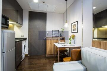 Compact kitchen and dining area with modern appliances and decor