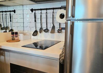 Modern kitchen with stainless steel appliances and white tile backsplash