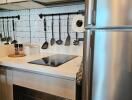 Modern kitchen with stainless steel appliances and white tile backsplash