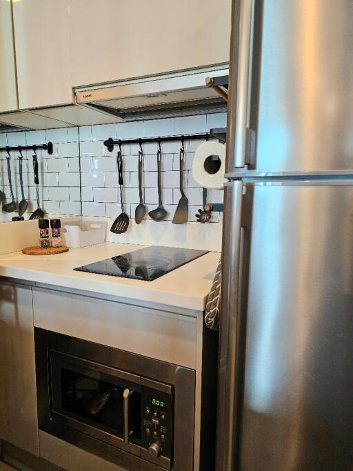 Modern kitchen with stainless steel appliances and white tile backsplash