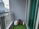 Modern balcony with artificial grass flooring and potted plants