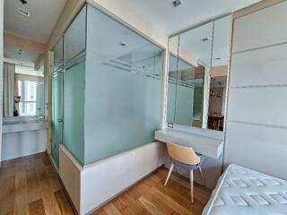 Modern bedroom with glass-paneled shower enclosure